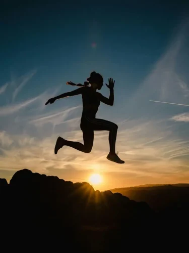 Woman Jumping over sun